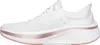 A side view of a white Skechers slip-on sneaker with pink and rose gold accents on the sole. Podgląd zdjęcia produktu