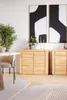 A modern living room with a wooden sideboard, a round dining table, and abstract art on the wall. Produktbild-Vorschau