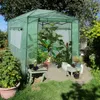 A green greenhouse filled with plants in a garden setting. Náhled obrázku produktu
