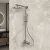 A modern bathroom with a shower system mounted on a marble-patterned wall. Produktbild-Vorschau