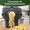 A Philips pasta maker extruding fresh noodles onto a wooden surface, with some finished pasta in the foreground. The top of the image has text and a green overlay. Produktbild-Vorschau
