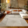 A modern living room with a sectional sofa, a large rug, and decorative elements. Náhľad obrázku produktu
