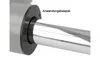 A close-up view of a black rubber fitting on a chrome pipe, with a gray cylindrical object in the background. Produktbild-Vorschau