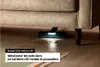 A vacuum cleaner head with LED lights is cleaning under a sofa on a wooden floor. Náhled obrázku produktu