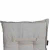A close-up view of a beige cushion with straps and buckles. Produktbild-Vorschau