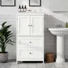 A white bathroom cabinet with two doors and two drawers, placed next to a pedestal sink. Produktbild-Vorschau