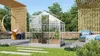 A modern backyard scene featuring a greenhouse, a hanging chair, and outdoor seating. Produktbild-Vorschau