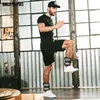 A man is doing a workout with ankle weights in a studio with large windows. Náhľad obrázku produktu