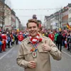 A man in a costume is participating in a street parade or festival. Anteprima dell’immagine prodotto
