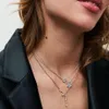 Close-up of a woman wearing multiple necklaces. Produktbild-Vorschau