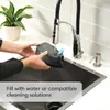 A person is filling a cleaning solution into a device over a sink. Voir les images du produit