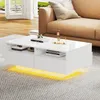 A modern white coffee table with LED lighting is placed on a gray rug in a living room setting, next to a tan sofa.