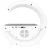 The back view of a white bedside lamp with a crescent-shaped light element and a base containing a speaker grille, ports, and controls. Náhled obrázku produktu