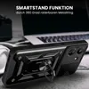 A black phone case with a ring stand is shown in a close-up shot, with a laptop and headphones blurred in the background. Produktbild-Vorschau