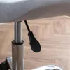 A close-up view of the height adjustment lever and gas lift cylinder of a gray office chair. Podgląd zdjęcia produktu
