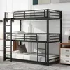 A triple bunk bed in a room with a dresser and a lamp. Produktbild-Vorschau