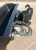 A close-up view of a black excavator bucket attachment with hydraulic hoses. Produktbild-Vorschau