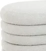 A close-up view of stacked, round, upholstered ottomans. Produktbild-Vorschau