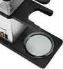 A close-up shot of a coffee maker's base and part of its body. Produktbild-Vorschau