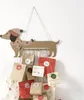 A handmade advent calendar shaped like a dachshund, with small gift bags hanging from its body. Anteprima dell’immagine prodotto