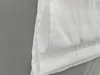 A close-up view of a white fabric roller blind, showing the texture and stitching. Produktbild-Vorschau