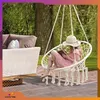 A person reading in a hanging chair outdoors, with furniture and greenery in the background. Produktbild-Vorschau