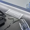 A sleek, modern countertop with a spilled drink and a pop-up power outlet. Anteprima dell’immagine prodotto