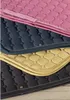 A stack of horse saddle pads in different colors. Produktbild-Vorschau