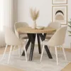 A dining table set in a room with artwork on the wall. Voir les images du produit
