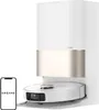 A white and gold robot vacuum cleaner docked in its charging station, with a smartphone displaying the Dreame logo in the foreground. Náhled obrázku produktu
