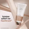 A Wella Professionals Fusion conditioner tube is displayed prominently against a backdrop of flowing fabric. Produktbild-Vorschau