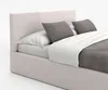 A close-up view of a bed with a headboard, pillows, and bedding. Náhled obrázku produktu