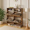 A shoe cabinet in a room with a plant and a floor lamp. Produktbild-Vorschau