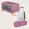 A pink travel crib is shown next to a white suitcase and a pink carrying bag, with an orange arrow indicating the crib can be packed into the bag. Anteprima dell’immagine prodotto