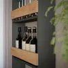 A close-up view of a wine glass rack with bottles stored below. Produktbild-Vorschau