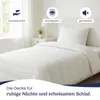 A neatly made bed with a white duvet and pillow in a bedroom setting. Produktbild-Vorschau