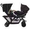 A child sits in the front seat of a Graco Stadium Duo double stroller, with a car seat attached in the rear position. Voir les images du produit