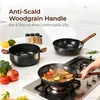 A kitchen scene with cookware on a stovetop and countertop. Produktbild-Vorschau