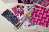 A Barbie doll and sewing supplies are laid out on a white surface, suggesting a fashion design or crafting activity. Produktbild-Vorschau