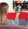 A woman is sitting on a couch, holding a remote control and looking at a TV screen displaying a grid of movie posters. Voir les images du produit