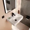 A modern bathroom sink with a black faucet and a small bar of soap. Produktbild-Vorschau