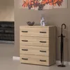 A modern chest of drawers with black handles, decorated with a bowl and a vase with dried flowers, stands next to an umbrella stand with an umbrella. A painting of autumn leaves hangs on the wall behind it. Podgląd zdjęcia produktu