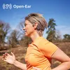 A woman is running outdoors while wearing open-ear headphones. Náhled obrázku produktu