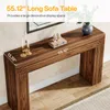 A long, narrow wooden console table with decorative elements on top, placed against a wall. Anteprima dell’immagine prodotto