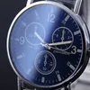Close-up of a blue analog watch face with silver hands and markings. Produktbild-Vorschau