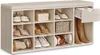 A shoe bench with multiple compartments and a drawer, filled with various shoes and a basket. Produktbild-Vorschau