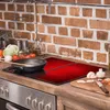 A kitchen counter with a stove, cooking utensils, and ingredients. Náhľad obrázku produktu