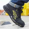 A close-up shot of a person's foot wearing a black and yellow U-Power safety shoe, with jeans rolled up. Anteprima dell’immagine prodotto