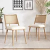 Two chairs with rattan backs and wooden legs are placed in a room with artwork and plants. Podgląd zdjęcia produktu