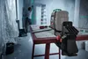 A person is using a laser level in a room under renovation. Produktbild-Vorschau